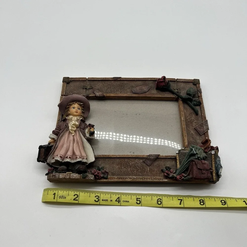 A Richesco Corporation Girl With Roses Suitcase Hand Painted Resin picture frame